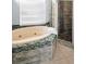 Bathroom features an oval tub, mosaic tile accents, and a glass shower at 1516 E Lake Woodlands Pkwy, Oldsmar, FL 34677