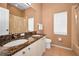 Full bathroom with double sinks, granite countertop, and ample lighting at 1516 E Lake Woodlands Pkwy, Oldsmar, FL 34677