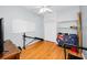 Bedroom with hardwood floors, ceiling fan, and closet with bi-fold doors at 1516 E Lake Woodlands Pkwy, Oldsmar, FL 34677