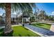 Inviting entrance to the Ardea Country Club featuring a covered walkway and lush landscaping at 1516 E Lake Woodlands Pkwy, Oldsmar, FL 34677