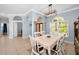 Open-concept dining room featuring stylish light fixture, and arched doorways at 1516 E Lake Woodlands Pkwy, Oldsmar, FL 34677