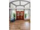 Detailed custom double doors flanked by grand columns and decorative transom window at 1516 E Lake Woodlands Pkwy, Oldsmar, FL 34677