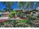 Stunning single-story home with lush landscaping, arched windows, and a terracotta roof at 1516 E Lake Woodlands Pkwy, Oldsmar, FL 34677