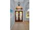 Inviting foyer featuring decorative glass doors and arched transom window at 1516 E Lake Woodlands Pkwy, Oldsmar, FL 34677