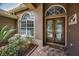 Elegant entryway featuring a beautiful glass door and ample natural light at 1516 E Lake Woodlands Pkwy, Oldsmar, FL 34677