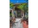 Close-up of a beautiful front door with decorative glass and potted plants at 1516 E Lake Woodlands Pkwy, Oldsmar, FL 34677