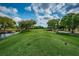 Golf course tee box with green fairways, mature trees, and a scenic pond at 1516 E Lake Woodlands Pkwy, Oldsmar, FL 34677