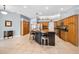 Open-concept kitchen with an island, wooden cabinets, and a seamless connection to the dining area at 1516 E Lake Woodlands Pkwy, Oldsmar, FL 34677
