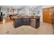 Kitchen island with granite countertop and stainless steel dishwasher overlooking the backyard for modern convenience at 1516 E Lake Woodlands Pkwy, Oldsmar, FL 34677