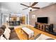 Spacious living room with hardwood floors, and an open layout connecting to the kitchen and dining areas at 1516 E Lake Woodlands Pkwy, Oldsmar, FL 34677