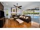 Cozy living room with a fireplace, hardwood floors, and a view of the screened in pool area at 1516 E Lake Woodlands Pkwy, Oldsmar, FL 34677