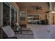 Covered patio with lounge chairs overlooking the screened pool area at 1516 E Lake Woodlands Pkwy, Oldsmar, FL 34677