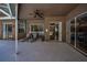 Covered patio with lounge chairs overlooking the screened pool at 1516 E Lake Woodlands Pkwy, Oldsmar, FL 34677