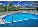 Beautiful pool and spa in a screened enclosure, surrounded by lush landscaping at 1516 E Lake Woodlands Pkwy, Oldsmar, FL 34677