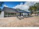 Relaxing pool area featuring lounge chairs, tables, umbrellas, and building access for poolside lounging and enjoyment at 1516 E Lake Woodlands Pkwy, Oldsmar, FL 34677