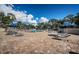 Spacious pool deck with lounge chairs and umbrellas under sunny skies and palm trees at 1516 E Lake Woodlands Pkwy, Oldsmar, FL 34677
