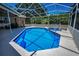 Gorgeous pool and spa in screened enclosure with lush landscaping at 1516 E Lake Woodlands Pkwy, Oldsmar, FL 34677