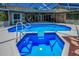An inviting screened-in pool and spa offer a refreshing escape, enhanced by ample seating areas for relaxation at 1516 E Lake Woodlands Pkwy, Oldsmar, FL 34677