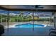 Sparkling pool and spa in screened enclosure with lush landscaping at 1516 E Lake Woodlands Pkwy, Oldsmar, FL 34677