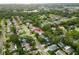 Neighborhood aerial view, highlighting the property's location amid mature trees at 1562 Coastal Pl, Dunedin, FL 34698