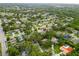 Expansive aerial view showcasing the residential neighborhood with lush greenery at 1562 Coastal Pl, Dunedin, FL 34698