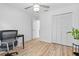 Bright bedroom featuring stylish light fixture, wood floors, and large closet at 1562 Coastal Pl, Dunedin, FL 34698