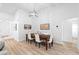 Inviting dining room with a wooden table set, pendant lighting, and light plank flooring at 1562 Coastal Pl, Dunedin, FL 34698