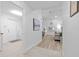Inviting hallway leads to a bright living room and other areas of the home at 1562 Coastal Pl, Dunedin, FL 34698