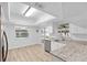 Eat-in kitchen with granite countertops, stainless steel appliances, and a view of the lanai offer an indoor/outdoor lifestyle at 1562 Coastal Pl, Dunedin, FL 34698
