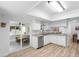 Bright kitchen boasts white cabinetry, stainless steel appliances, and sliding door access to the lanai at 1562 Coastal Pl, Dunedin, FL 34698