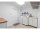 Convenient laundry room with modern washer, dryer, utility sink, and storage at 1562 Coastal Pl, Dunedin, FL 34698