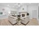 Bright living room with high ceilings, a cozy fireplace, and sliding glass doors for seamless indoor-outdoor living at 1562 Coastal Pl, Dunedin, FL 34698