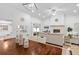 Open-concept living area with modern lighting, fireplace, and dining table, ideal for entertaining and Gathering gatherings at 1562 Coastal Pl, Dunedin, FL 34698