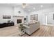 Bright living room with stone fireplace, comfortable seating, and modern decor, perfect for relaxing and entertaining guests at 1562 Coastal Pl, Dunedin, FL 34698