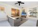 Outdoor patio with comfortable seating, ceiling fan, and view to the pool and kitchen at 1562 Coastal Pl, Dunedin, FL 34698
