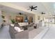 Beautiful patio area with comfortable seating, ceiling fans, and an outdoor bar at 1562 Coastal Pl, Dunedin, FL 34698