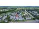 Expansive aerial shot showcasing a neighborhood with lush greenery, orderly streets, and diverse housing at 16109 Rambling Vine E Dr, Tampa, FL 33624