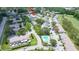 Community aerial view featuring lush green trees, pool, a golf course, and ample parking at 16109 Rambling Vine E Dr, Tampa, FL 33624