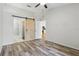 Bedroom showcasing a sliding barn door, closet, and ensuite bathroom at 16109 Rambling Vine E Dr, Tampa, FL 33624