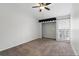 Neutral bedroom featuring plush carpet, window with blinds, ceiling fan, closet, and fresh white walls at 16109 Rambling Vine E Dr, Tampa, FL 33624