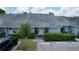Charming light blue home with a well-manicured front yard, parking space, and a welcoming entrance at 16109 Rambling Vine E Dr, Tampa, FL 33624