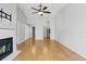 Spacious living room with a fireplace, ceiling fan, and hardwood flooring at 16109 Rambling Vine E Dr, Tampa, FL 33624