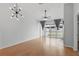 Bright living room featuring stylish lighting, hardwood floors, and a sliding glass door at 16109 Rambling Vine E Dr, Tampa, FL 33624