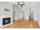 Bright living room featuring a fireplace, ceiling fan, and modern light fixture at 16109 Rambling Vine E Dr, Tampa, FL 33624