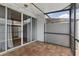 Enclosed patio area with tiled floor, sliding glass door, privacy fence, and string lighting at 16109 Rambling Vine E Dr, Tampa, FL 33624