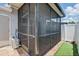 Screened patio with tile flooring, privacy fence, access door to the outside, and mini-split air conditioner unit at 16109 Rambling Vine E Dr, Tampa, FL 33624