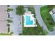 Aerial view showcasing the community pool, surrounding trees, and nearby parking spots at 16109 Rambling Vine E Dr, Tampa, FL 33624