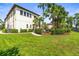 Spacious backyard features lush landscaping, palm trees, and a patio area for outdoor enjoyment at 17301 Ladera Estates Blvd, Lutz, FL 33548