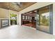Access indoor game room from this elegant covered balcony featuring a fireplace and expansive views at 17301 Ladera Estates Blvd, Lutz, FL 33548