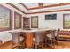 The elegant game room features a bar area with wood cabinetry and granite countertops at 17301 Ladera Estates Blvd, Lutz, FL 33548